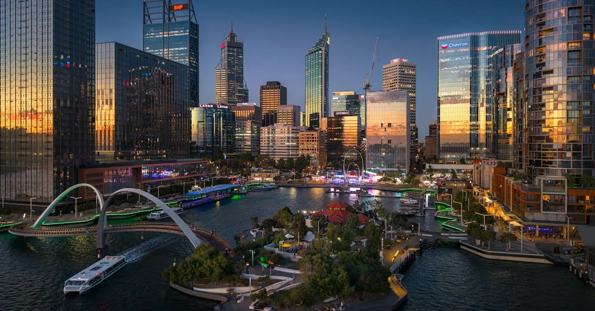 Explore the dynamic skyline of Perth reflecting city life at sunset over the Swan River.