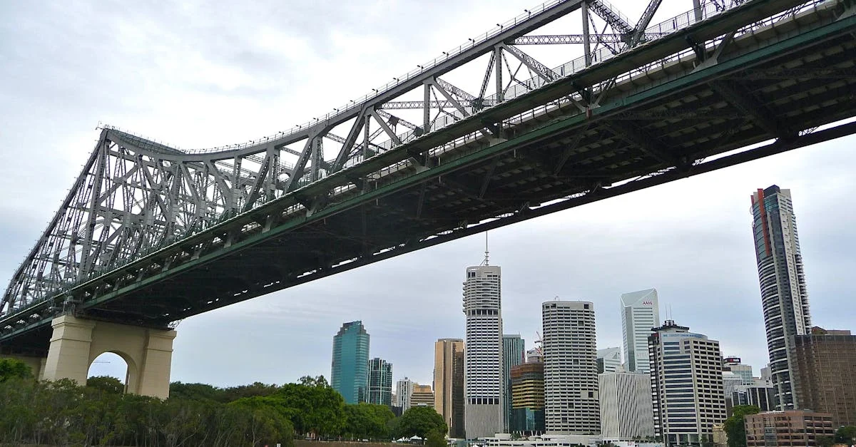 View of the Story Bridge over the Brisbane River with modern skyscrapers in the city skyline.